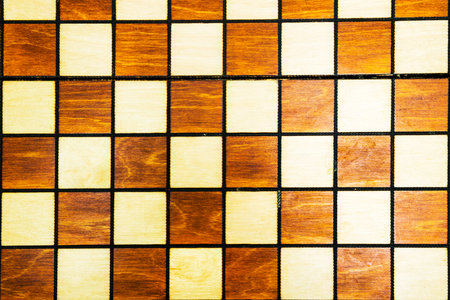 Wooden background of a chessboard. Vintage texture of a chess Board. White and black squares for a...