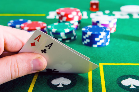 A man shows his deck of aces during a poker game. High quality photo