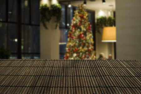 Wooden table space platform fir tree with lights and blurred bokeh Christmas happy New year...