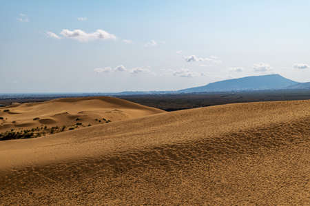 Picturesque Sarykum dune. Sandy mountain on the background of mountains, the Caucasus. Dagestan, Russia.の写真素材