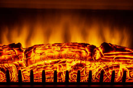 Artificial electric fireplace with orange, red and yellow flames.の写真素材