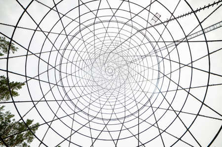 Bottom-up view of the Shukhov Tower on the Oka River, Nizhny Novgorod region, Russia. A beautiful web of metal structures and small.の写真素材