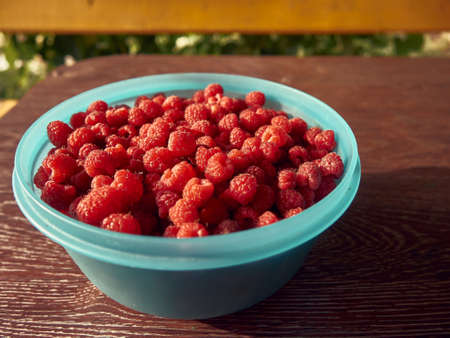 red raspberries in a plateの写真素材