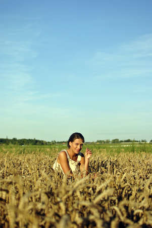 Girl in costume sitting in the Rye in the countryside. Space for textの写真素材