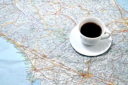 cup of coffee on the map. conceptの写真素材