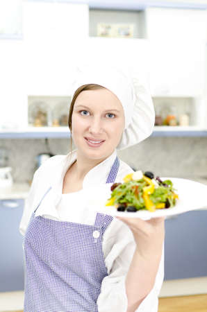 Pretty cook chief holding saladの写真素材