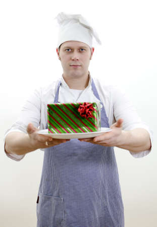chief cook with a gift on a plateの写真素材