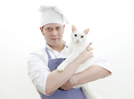 Portrait of handsome chief cook with white cat in handsの写真素材