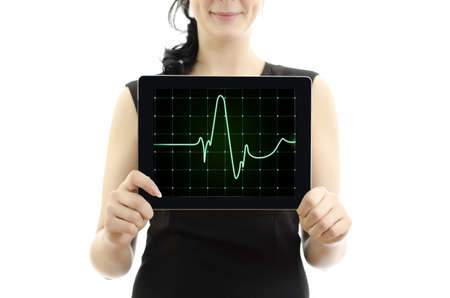 Woman holding tablet pc. Concept: cardiogram with heartbeat. isolated on white.の写真素材
