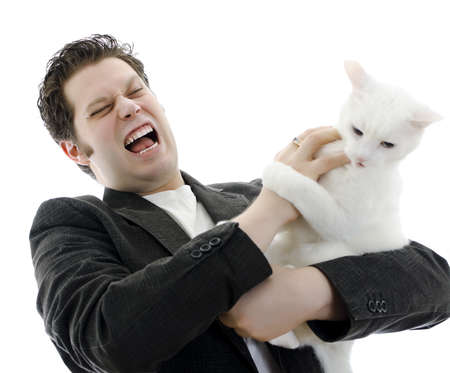 Man fighting with white cat. Isolated on white.の写真素材