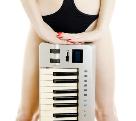 Part of Woman body in black swimsuit with Piano keyboard  Isolated on white の写真素材