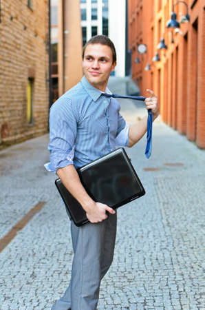 Young guy posing with a laptop on the street.の写真素材