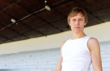 Portrait of athletic male against empty sport stadiumの写真素材