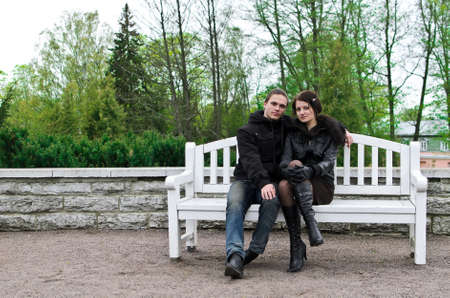 Portrait of happy couple on park bench の写真素材