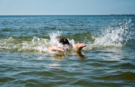 Young male swimming in the sea/oceanの写真素材