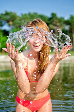 Pretty woman having fun in the seaの写真素材