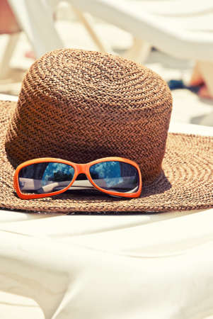 Straw hat with sunglasses on the longueの写真素材