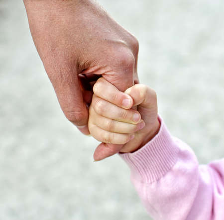 Child holding mother's handの写真素材
