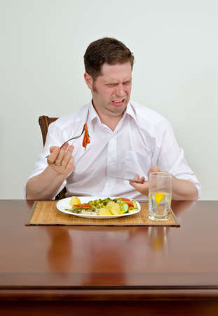 Man is disappointed with his dishの写真素材