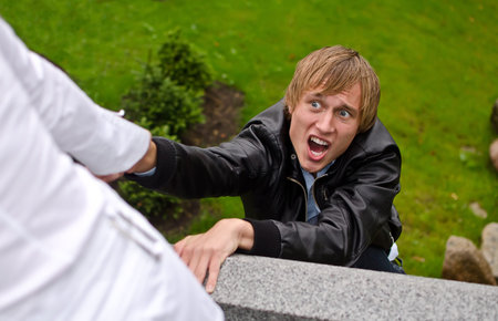 Young man falling down from the bridge