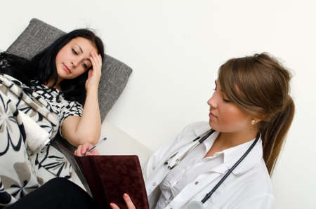 Female doctor visiting patient at homeの写真素材