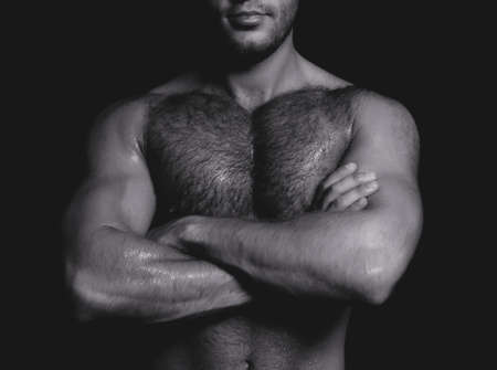 Portrait of a handsome guy with crossed hands. Black and whiteの写真素材