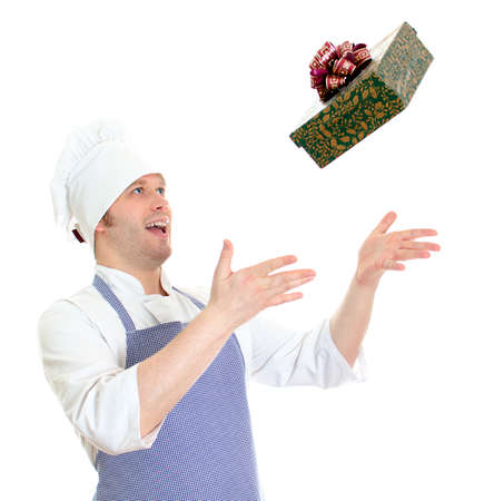 Young chef cook throwing present box. Isolated on whiteの写真素材