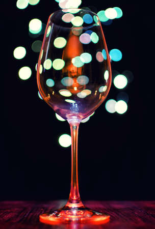 Empty wineglass on bokeh lights backgroundの写真素材