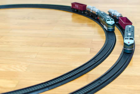 Two toy trains on wooden floorの写真素材