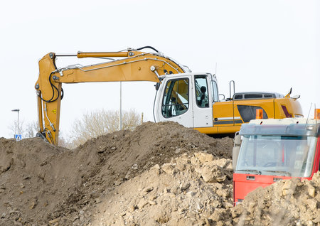 Excavator and truck on construction site 