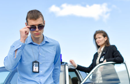Two FBI agents near the car with flasher