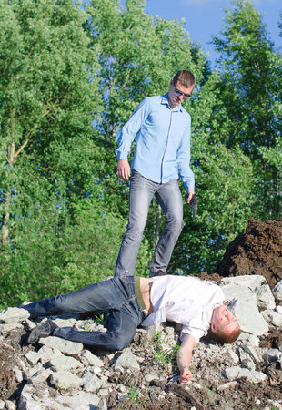 Offender gets rid of the corpse, throws off a cliffの写真素材