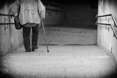 Rare view of senior coming down stairs. Black and whiteの写真素材