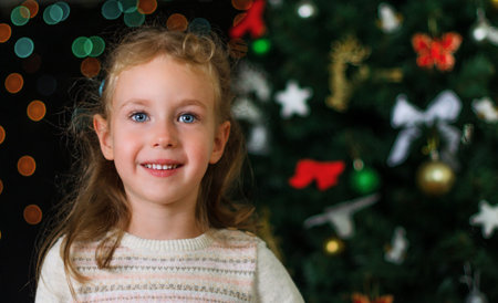 Little smiling girl over christmas decorations