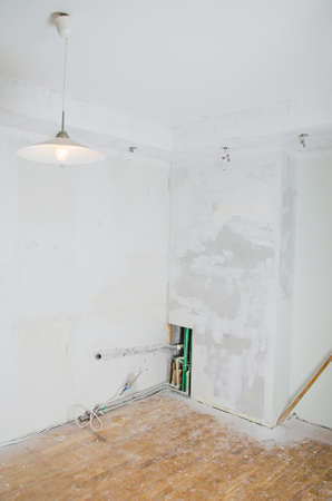 Room renovation  Gypsum plasterboard with undone socket bulbs の写真素材