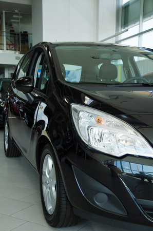 Black new car at dealership salon 