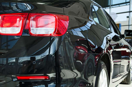 Black new car at dealership salon の写真素材