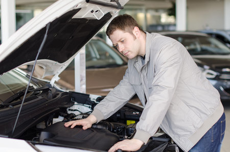 Man examining new car at the dealership.