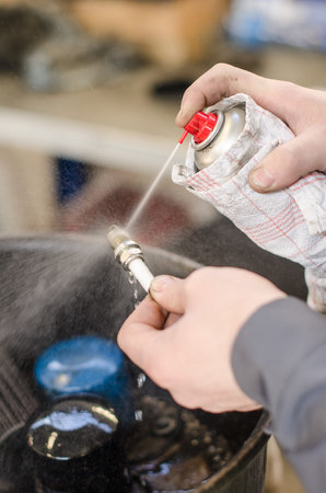 Spark plug cleaning in repair shop 
