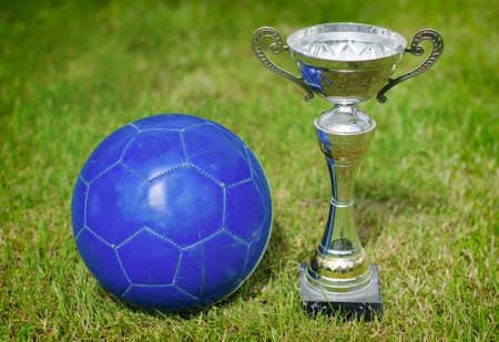 Victory celebration  Soccer trophy near the ball の写真素材