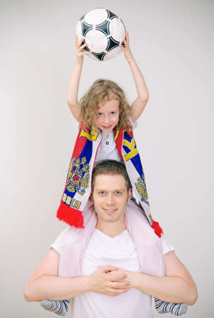 Father and daughter supports their sports team の写真素材