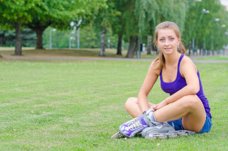 Young woman on roller skates in the park の写真素材