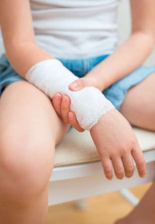 Child arm with gauze bandage on it の写真素材