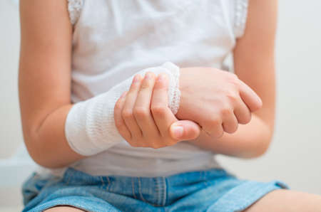 Child arm with gauze bandage on it の写真素材