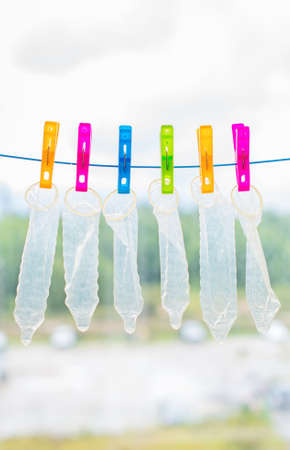 Six condoms drying on the rope. Funny conceptual photo.の写真素材