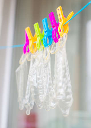Six condoms drying on the rope. Funny conceptual photo.の写真素材