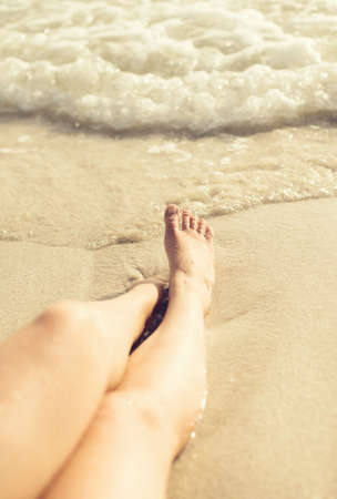Woman lying on the beach. Vintage effect.の写真素材