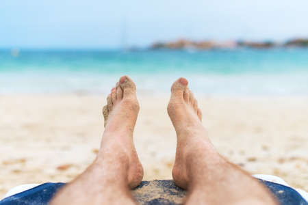 Man sunbathing on lounger. Legs.の写真素材