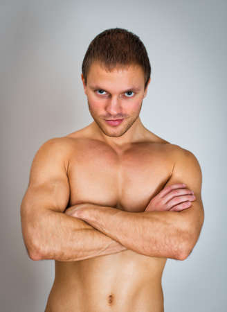 Muscular male model with arms folded.の写真素材