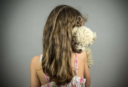Little girl crying in the corner. Domestic violence concept.の写真素材